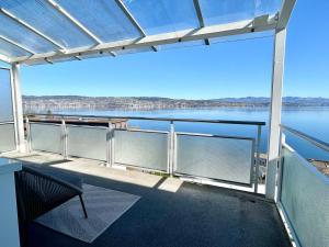 a balcony with a view of the water at Horizon 62 I Zürich Lakeside Apartment I Modern I Free Parking I Self-Check-In in Richterswil