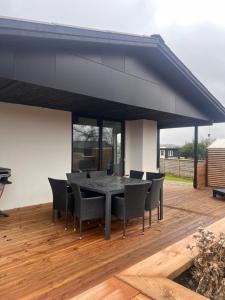 a dining area with a table and chairs on a deck at House with a lovely location in Børkop