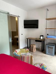 a living room with a flat screen tv on the wall at Guesthouse Grand View in Malcesine