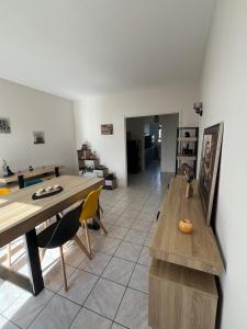a living room with a table and a dining room at Appart Cosy Centre ville -proche gare in Châtellerault