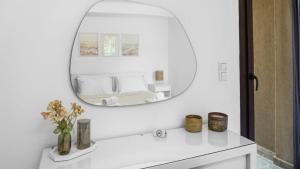 a bathroom with a mirror and a white sink at Luxury Living Peramos in Nea Peramos +33 photos
