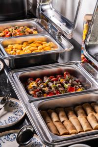 a buffet line with trays of food and hot dogs at Grand Dior in Tashkent +81 photos