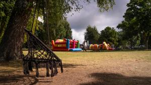 a park with a playground with slides at Domki Aleja Róż in Międzyzdroje