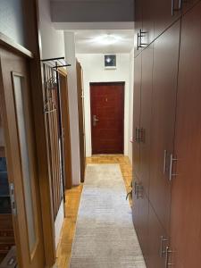 a hallway with wooden doors and a rug in a room at Lana in Trebinje