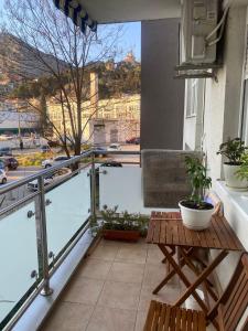a balcony with a table and a view of a city at Lana in Trebinje