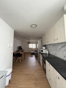 a kitchen with white cabinets and black counter tops at El Puertito Beach Retreat in Agaete +38 photos