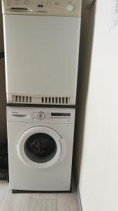 a white washer and dryer in a room at Pension Bei Valentina in Wertheim