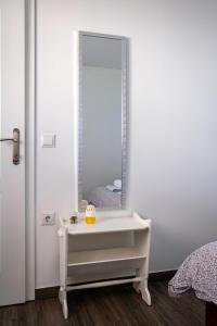 a bathroom with a white vanity and a mirror at Apartman Marija in Bošnjaci +48 photos