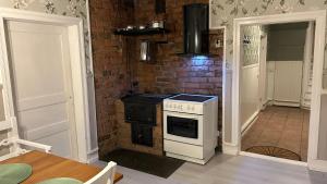 a kitchen with a stove and a brick wall at Ranchen B&B in Enköping