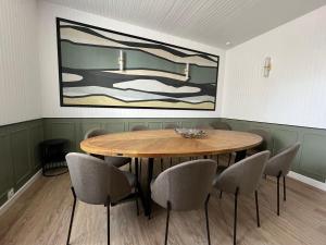 a dining room with a wooden table and chairs at Maison WILSON in Blois +11 photos