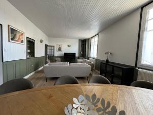 a living room with couches and a table at Maison WILSON in Blois