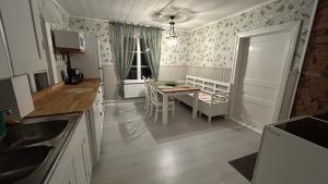 a kitchen with a table and a dining room at Ranchen B&B in Enköping +3 photos
