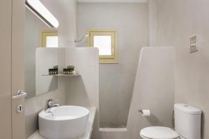 a white bathroom with a sink and a toilet at Kastella Sunset Villa Three in Kithnos +19 photos