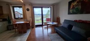 a living room with a couch and a table at Donaublick Möhringen in Tuttlingen