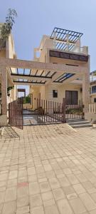 a building with a gate and a patio at Silver Sand Resorts With Private Swimming Pool in Chennai