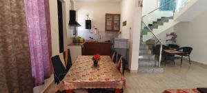 a dining room table with a vase of flowers on it at Silver Sand Resorts With Private Swimming Pool in Chennai