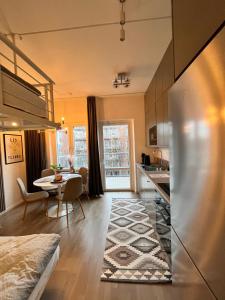a kitchen and living room with a table and a dining room at Nordic NOVA Studio in Stockholm