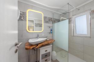 a bathroom with a sink and a mirror at LA TERRAZZA appartamento di vacanza in Collina d'Oro