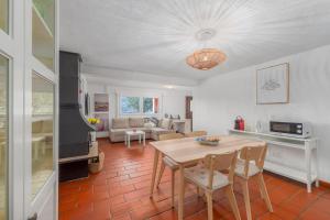 a kitchen and living room with a table and chairs at LA TERRAZZA appartamento di vacanza in Collina d'Oro