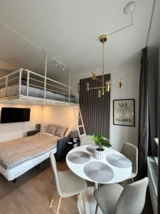 a bedroom with a bed and a table and chairs at Nordic NOVA Studio in Stockholm