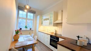 a kitchen with a table and a dining room at Old Town Gdansk Olives Marina Apt 2 min walk to Motlawa River in Gdańsk