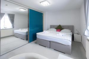 a bedroom with two beds and a mirror at Landhaus Süchterscheid in Süchterscheid +10 photos