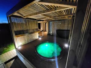 an outdoor hot tub on a deck at night at La cabane des folies in Montmédy