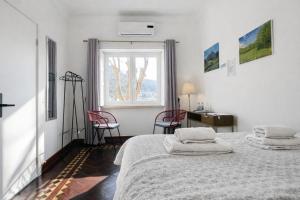a bedroom with a bed with two pillows on it at Happy Sintra Inn Guesthouse & Breakfast in Sintra