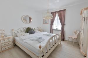 a bedroom with a white bed with towels on it at Landhaus Süchterscheid in Süchterscheid