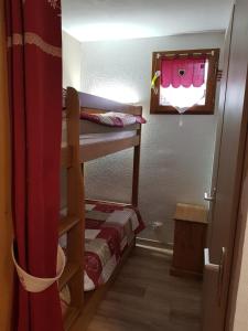 a small room with a bunk bed and a window at Abondance studio la marmotte in Abondance
