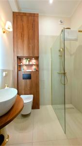 a bathroom with a toilet and a glass shower at Old Town Gdansk Olives Marina Apt 2 min walk to Motlawa River in Gdańsk +19 photos