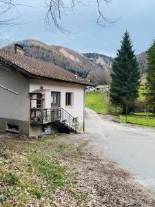 a house with a balcony on the side of a road at Gîte de la forêt in Mont-de-Vougney