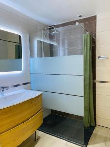 a bathroom with a sink and a mirror at Gîte de la forêt in Mont-de-Vougney +12 photos