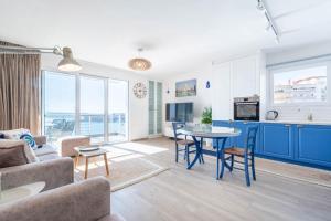 a living room with a couch and a table at Blue Eye Apartment in Sarandë