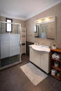 a bathroom with a sink and a shower at Villa Anemos in Nafplio +21 photos
