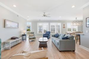 a living room with a couch and a table at Anchor Down Luxury Ocean View Beach House w Pool in Myrtle Beach