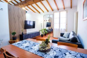 a living room with a table and a couch at La Dolce Imola-Bilocale in centro storico in Imola