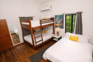 a bedroom with two bunk beds and a window at Casa Milo in Managua