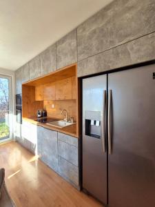 a kitchen with a stainless steel refrigerator and a sink at Garden Residence in Nitra +10 photos