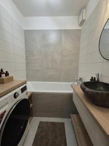 a bathroom with a sink and a washing machine at Garden Residence in Nitra