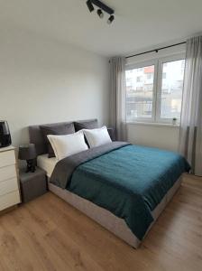 a bedroom with a large bed and a window at Garden Residence in Nitra