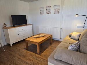 a living room with a couch and a coffee table at Sandra Fewo nähe Rømø in Bredebro in Bredebro