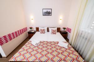 a small room with a bed and two tables at Caravan Boutique Ichan Kala in Khiva