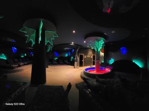 a room with two trees in the dark at Apt in the Sky - Kopaonik Kraljevi Čardaci in Kopaonik +31 photos