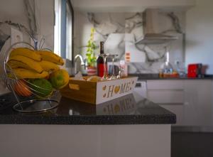 a bowl of fruit on a counter in a kitchen at Moonfall House in Arco da Calheta