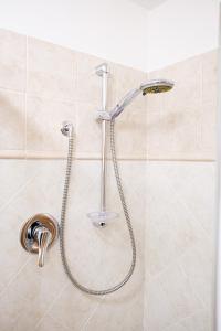 a shower with a hose in a bathroom at La Dolce Imola-Bilocale in centro storico in Imola +26 photos