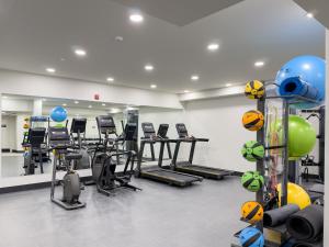 a gym with a bunch of exercise bikes and balls at Modern mountain luxury with stunning views in Canmore