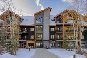 an exterior view of an apartment building in the snow at Modern mountain luxury with stunning views in Canmore
