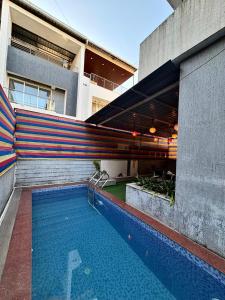 a swimming pool in front of a building at SilverOak 4bhk Villa in Jāmb