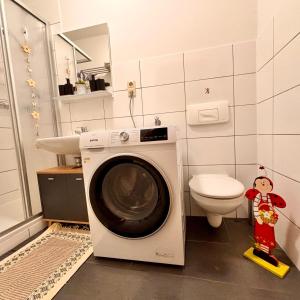 a washing machine in a bathroom with a toilet at Ferienwohnung Meerane Zentrum in Meerane